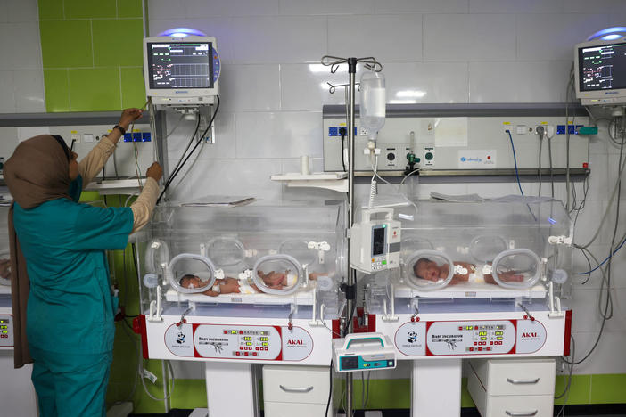 A Palestinian medic cares for babies born preterm at a hospital in Rafah in the southern Gaza Strip on April 24.