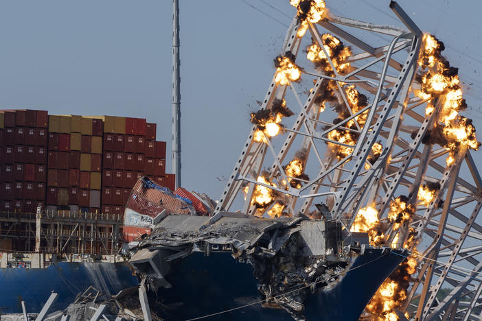 Explosive charges are detonated to bring down sections of the collapsed Francis Scott Key Bridge resting on the container ship Dali on Monday in Baltimore.