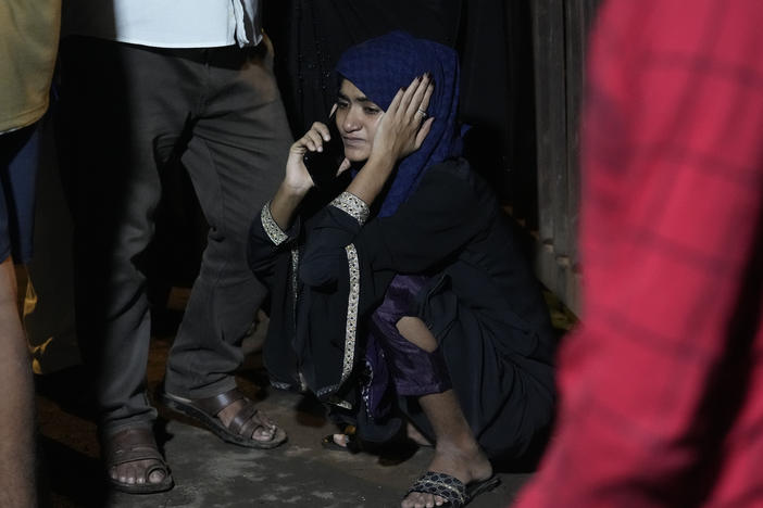 A girl whose relative is missing speaks on the phone at the site of a collapsed billboard following heavy rain and thundershowers in Mumbai, India, on Monday.
