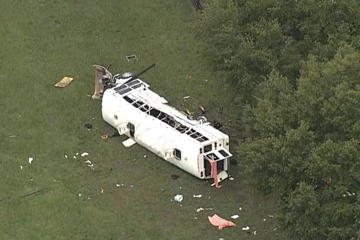 Emergency personnel work the scene of a deadly crash on Tuesday, in Marion County, Fla. The Florida Highway Patrol says a bus carrying farmworkers overturned, killing several people and injuring other passengers.