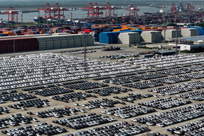 China is aiming to become a global automotive powerhouse, particularly when it comes to electric vehicles. Here, cars wait to be loaded onto a ship at a port in Nanjing.