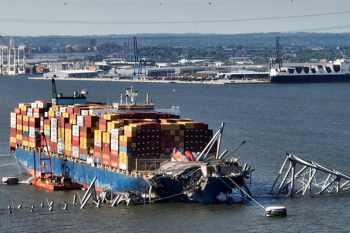 In this aerial view, a steel truss from the destroyed Francis Scott Key Bridge that was pinning the container ship Dali in place was detached from the ship using a controlled detonation of explosives in the Patapsco River on Monday in Baltimore, Md.