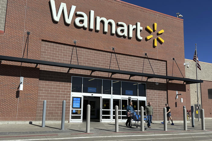 Shoppers exit a Walmart store, on Feb. 21, 2024, in Englewood, Colo. Walmart on Tuesday announced layoffs affecting several hundred jobs at the retail giant's campus offices.