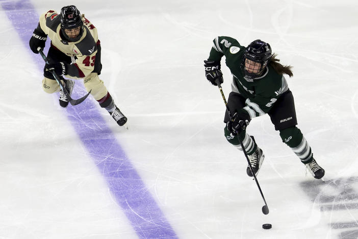 Boston defender Emily Brown (2) is defended by Montreal forward Kristin O'Neill (43) during the third period of a PWHL playoff hockey game Tuesday, May 14, 2024, in Lowell, Mass. (AP Photo/Mark Stockwell)
