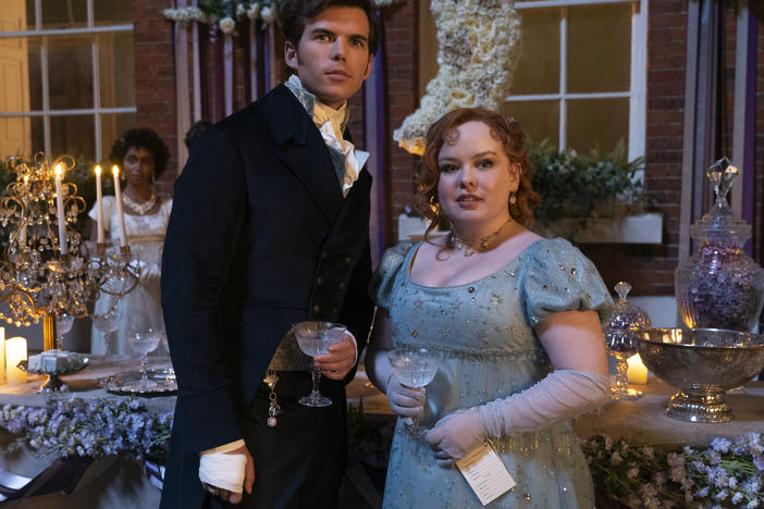 Luke Newton as Colin Bridgerton and Nicola Coughlan as Penelope Featherington.