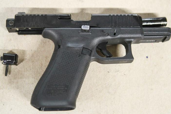 A Glock pistol with an illegal conversion device, sometimes referred to as a Glock switch. The small piece, which is illegal and not manufactured by Glock, can convert a semi-automatic pistol into a fully automatic one.