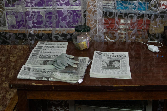 Editions of <em>Peremoha</em> sit on a table near the archives.