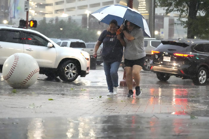 Fans make their way into Minute Maid Park as a severe thunderstorm hit before a baseball game between the Oakland Athletics and the Houston Astros, Thursday, May 16, 2024, in Houston.