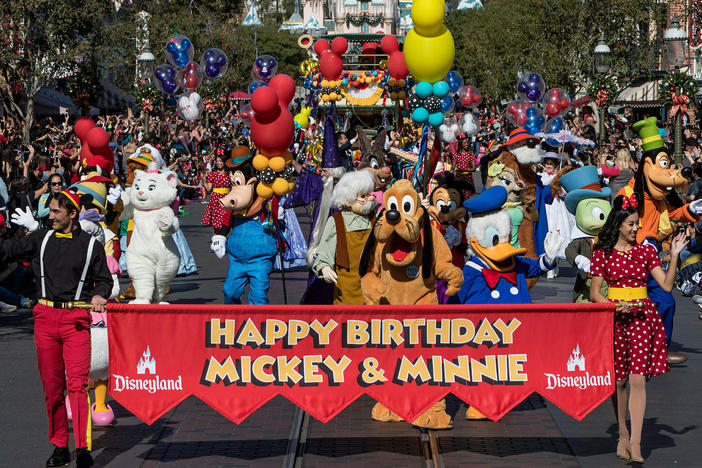 Disney characters lead a parade to celebrate Mickey Mouse's 90th birthday at Disneyland in November 2018.