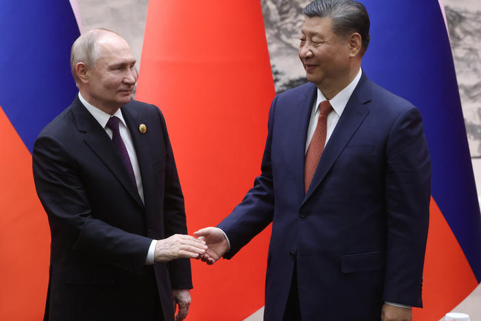 Russian President Vladimir Putin and Chinese President Xi Jinping shake hands during a bilateral meeting on Thursday in Beijing, China.