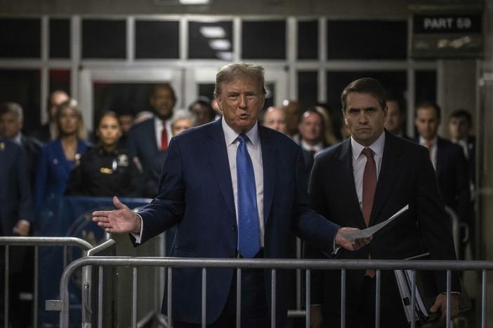Former President and Republican presidential candidate Donald Trump speaks to members of the media before entering the courtroom with his attorney Todd Blanche (right) at Manhattan criminal court in New York City, on Monday.