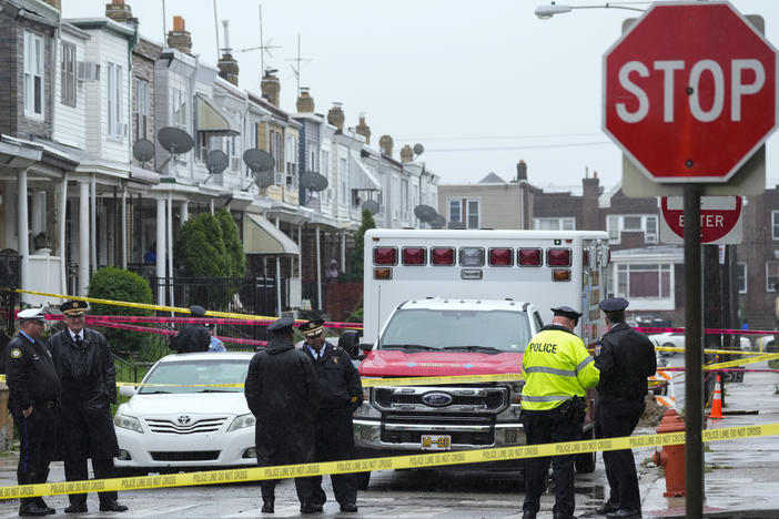 Law enforcement gather at the scene of a fatal shooting in Philadelphia on April 28, 2023.