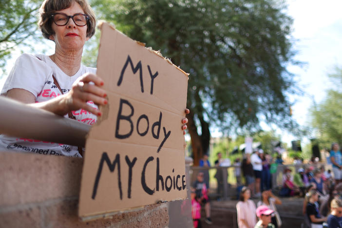 A protestor attends a Women's March rally in Phoenix, Arizona in 2022.