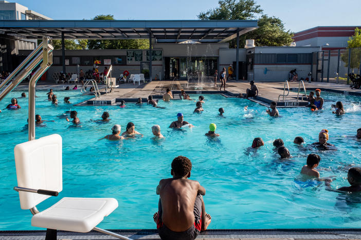A child watches others swim at the Emancipation Swimming Pool in Houston on July 19, 2022.
