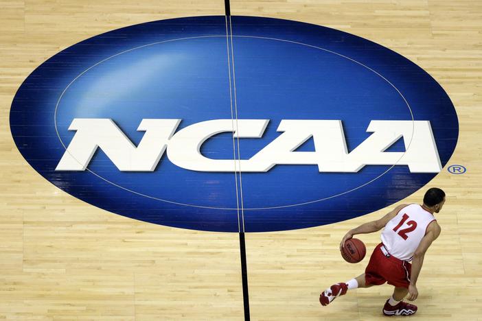 FILE - Wisconsin's Traevon Jackson dribbles past the NCAA logo during practice at the NCAA men's college basketball tournament March 26, 2014, in Anaheim, Calif.