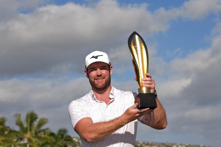 Grayson Murray holds the trophy after winning the Sony Open golf event, on Jan. 14, 2024, at Waialae Country Club in Honolulu. The 30-year-old died on Saturday, according to PGA Tour officials.