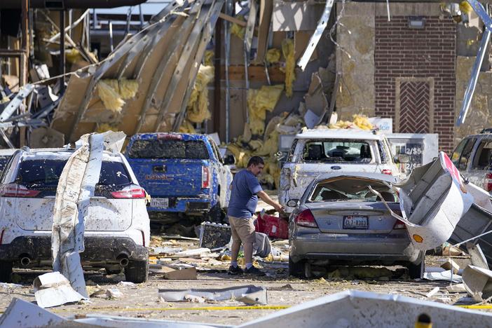 A man looks at a damaged car in Valley View, Texas, on Sunday, May 26 the day after a tornado hit.