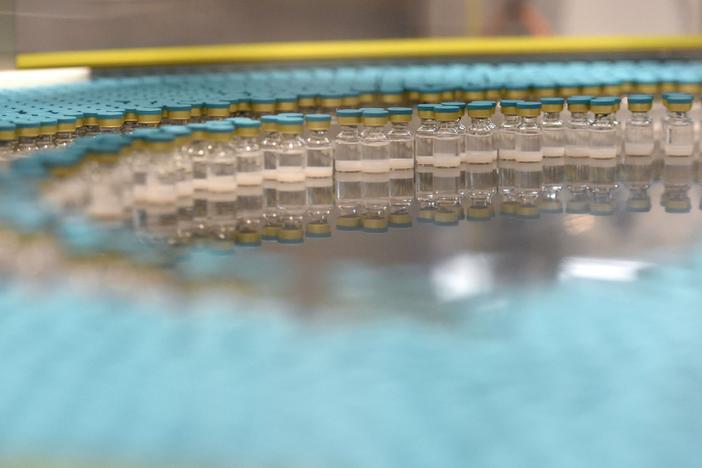 View of vials on a production line at the factory of British multinational pharmaceutical company GlaxoSmithKline (GSK) in Saint-Amand-les-Eaux, northern France, on December 3, 2020, where the adjuvant for Covid-19 vaccines will be manufactured. 