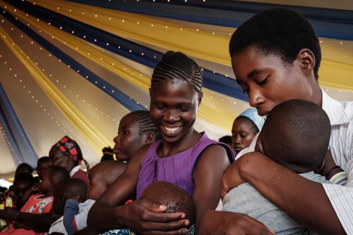 Mothers participate in a pilot program for one of two new malaria vaccines.