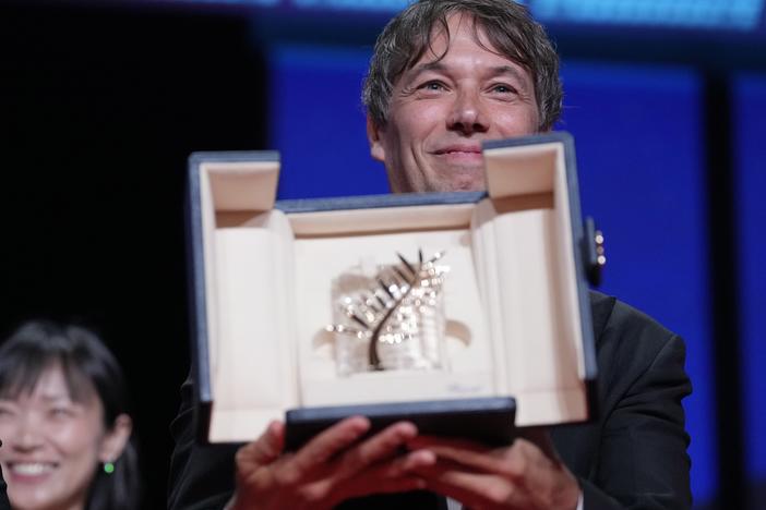 Sean Baker holds the Palme d'Or for the film <em>Anora</em>, during the awards ceremony of the 77th international film festival in Cannes, southern France, on Saturday.