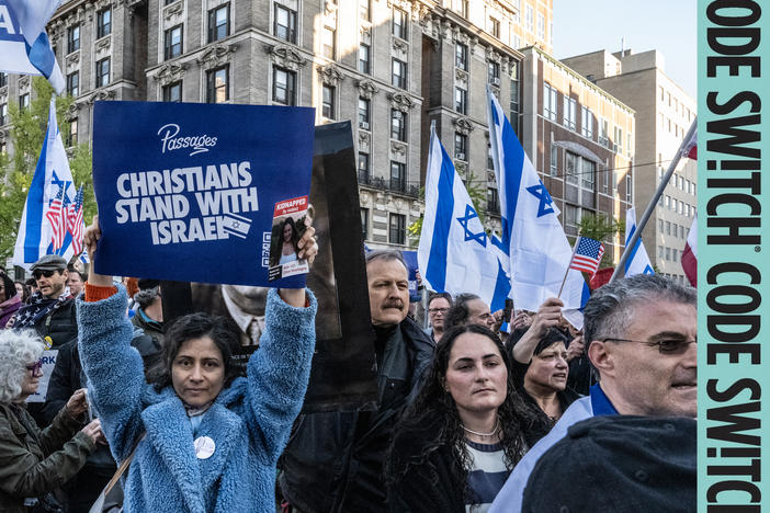At a march in support of Israel, one woman holds a sign saying, "Christians Stand with Israel."