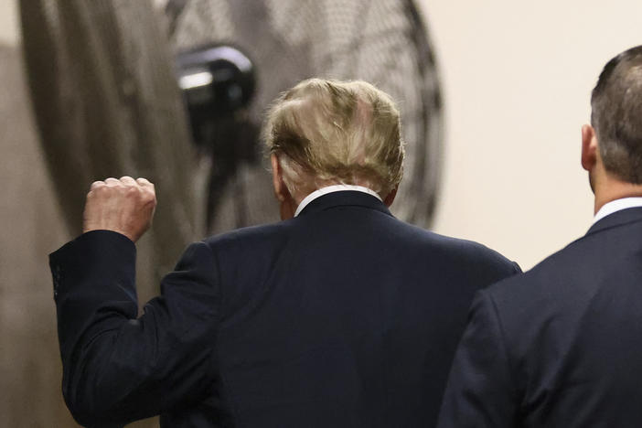 Former US President Donald Trump raises his fist as he leaves the courtroom during a break in his criminal trial for allegedly covering up hush money payments at Manhattan Criminal Court in New York City, on May 28, 2024.
