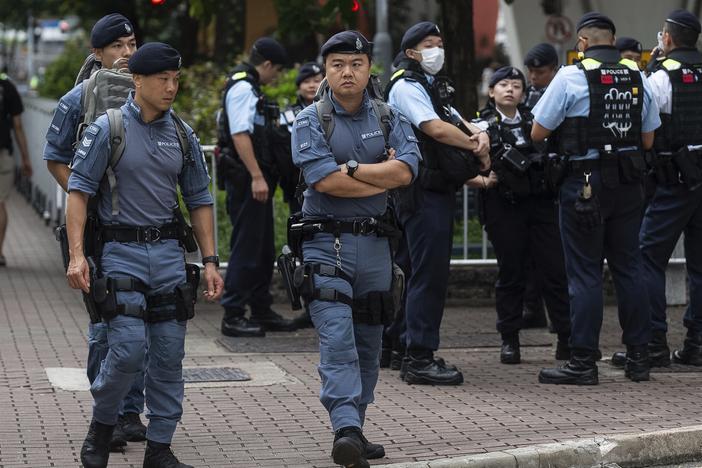 Police officers stand guard outside the West Kowloon Magistrates' Courts in Hong Kong on Thursday. 