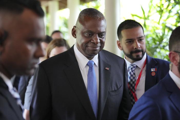 U.S. Secretary of Defense Lloyd Austin, center, walks out after a bilateral meeting with China's Defense Minister Dong Jun on the sidelines of the 21st Shangri-La Dialogue summit at the Shangri-La Hotel in Singapore on Friday.