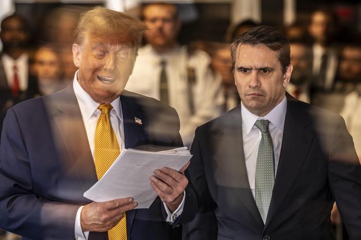 Former U.S. President Donald Trump speaks to the media as he arrives with attorney Todd Blanche.