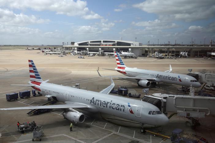 Three Black men have filed a lawsuit against American Airlines saying they were victims of “blatant and egregious racial discrimination” after being removed from a flight. Above, American Airlines planes are seen at Dallas-Fort Worth International Airport in June 2018. 