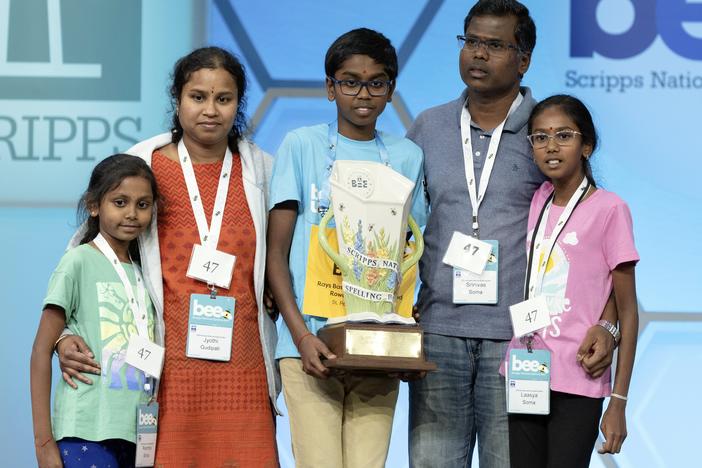Bruhat Soma, 12, of Tampa, Fla., stands on stage with his family after winning the Scripps National Spelling Bee, in Oxon Hill, Md., on Thursday night. 