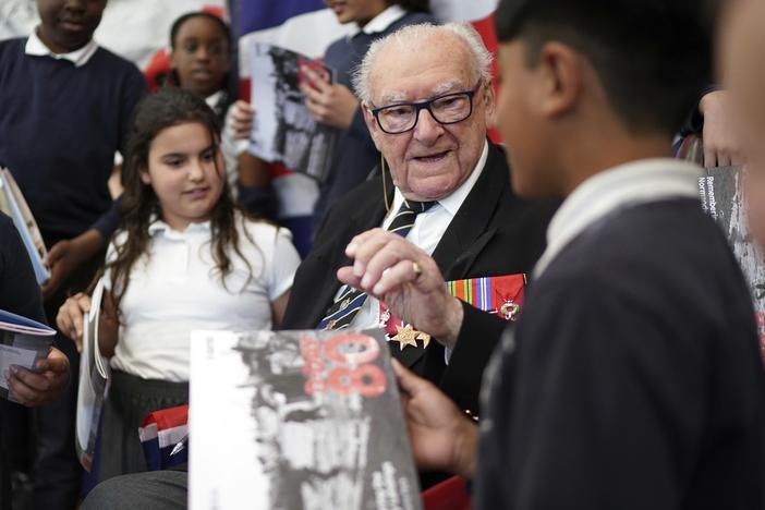 D-Day veteran and Ambassador for the British Normandy Memorial Ken Hay, 98, who served with the 4th Dorset Regiment, speaks to children during a visit to Rush Green Primary School in Dagenham, England, on Monday, May 20, 2024, ahead of the 80th anniversary of the D-Day landings.