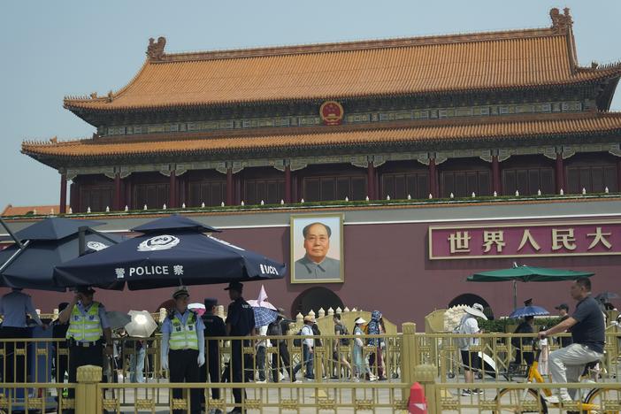 Police officers watch over Tiananmen Gate on Tuesday in Beijing. As Beijing's toughened political stance effectively extinguished any large-scale commemorations within its borders, overseas commemorative events have grown increasingly crucial for preserving memories of the Tiananmen crackdown.