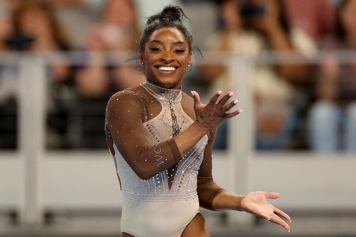 Simone Biles smiles during her floor exercise routine at the U.S. Gymnastics Championships on Sunday. 