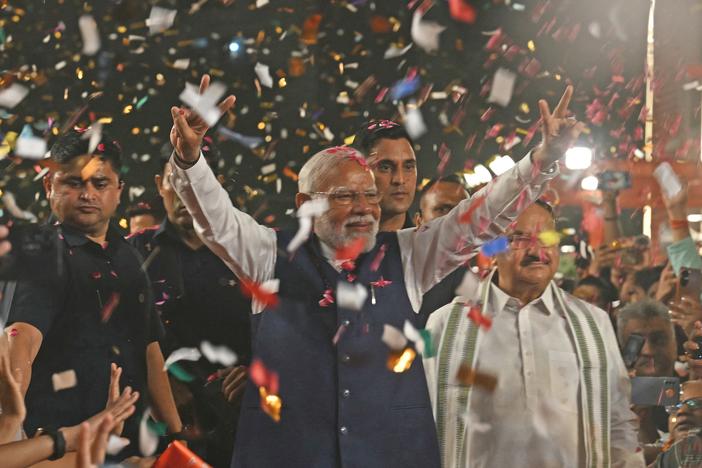 India's Prime Minister Narendra Modi flashes victory signs as he arrives at the Bharatiya Janata Party (BJP) headquarters to celebrate the party's win in the country's general election, in New Delhi, on Tuesday.