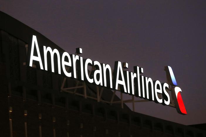 The NAACP is calling on American Airlines to provide an update on the pending investigations involving passengers and claims of racial discrimination. Here, the American Airlines logo stands atop the American Airlines Center on Dec. 19, 2017, in Dallas.