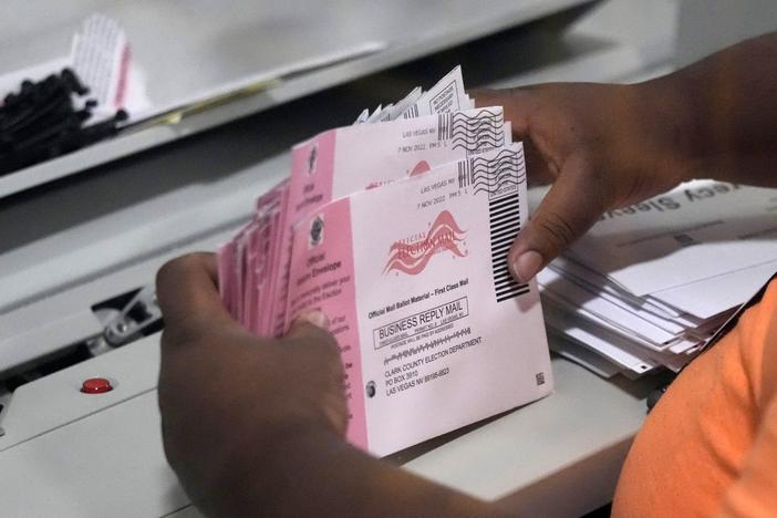 An election worker prepares mail ballots at the Clark County Election Department on Nov. 8, 2022, in Las Vegas. The Republican National Committee and the Trump campaign have filed a federal lawsuit seeking to prevent Nevada from counting mail ballots received after Election Day, as state law permits.