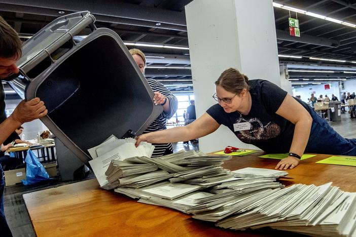 Elections workers empty a bin to count postal ballots for the European Union elections in Frankfurt, Germany, on Sunday.