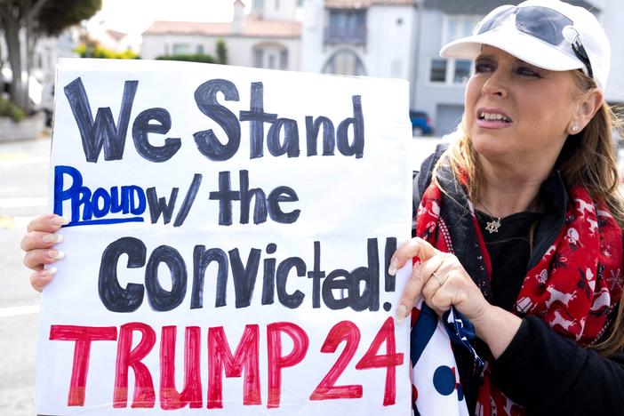 A supporter outside a fundraising event for Donald Trump in San Francisco on Thursday isn't put off by his conviction.