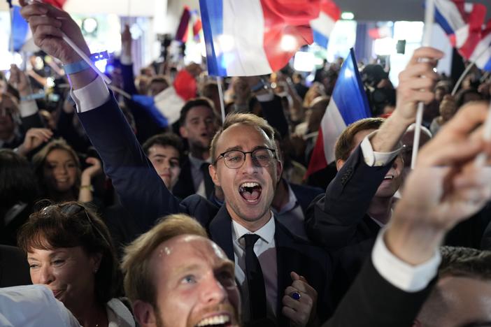 Supporters of the French far-right National Rally react at the party election night headquarters on Sunday in Paris. 