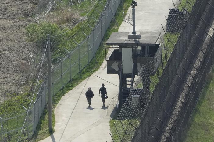 South Korean army soldiers patrol along the barbed-wire fence in Paju, South Korea, near the border with North Korea, on April 23, 2024.
