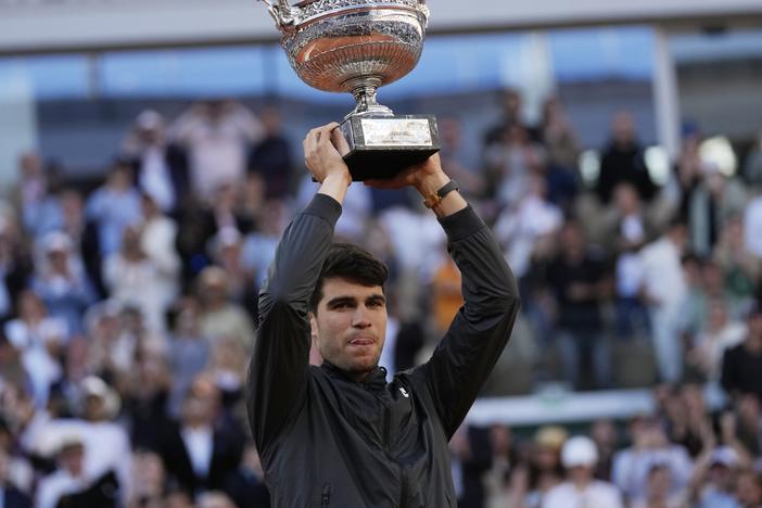 Winner Spain's Carlos Alcaraz celebrates with the trophy as he won the men's final match of the French Open tennis tournament against Germany's Alexander Zverev at the Roland Garros stadium in Paris on Sunday.