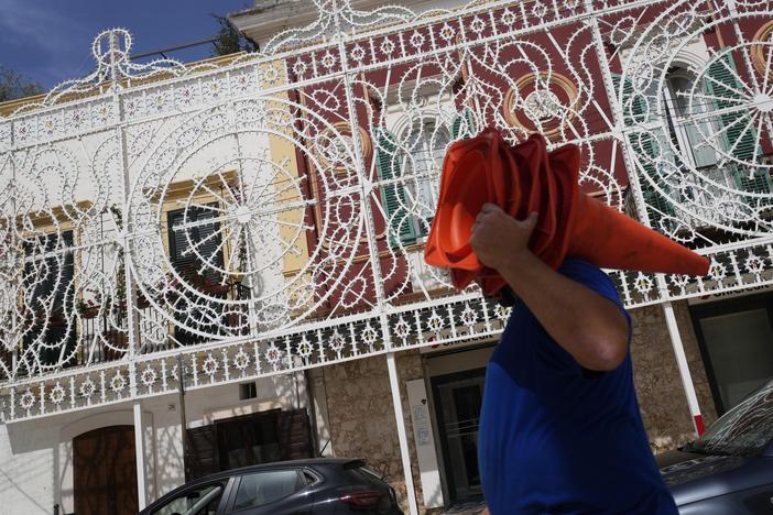 Workers give the finishing touches to the illumination set for the Patron Saint feast in Fasano, near Borgo Egnazia, Italy, on Wednesday, June 12, 2024. A Group of Seven summit aiming to consolidate support for Ukraine opened Thursday under a vastly different political landscape than even a few days ago after European Parliament elections jolted the leaders of France and Germany and emboldened Italian Premier Giorgia Meloni.