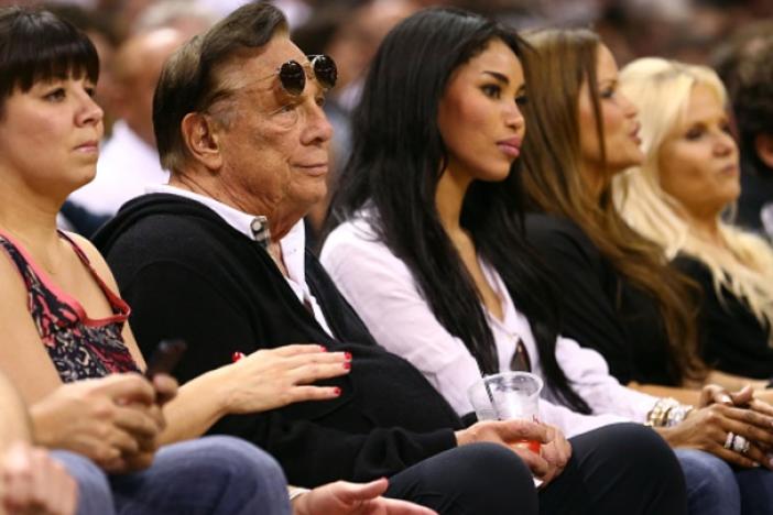 Former Los Angeles Clippers team owner Donald Sterling and V. Stiviano watch the San Antonio Spurs play against the Memphis Grizzlies during the Western Conference Finals of the 2013 NBA Playoffs