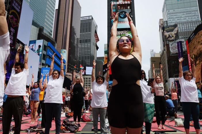 People participate in a mass yoga session on International Yoga Day in Times Square on June 21, 2023 in New York City. The CDC finds about 1 in 6 adults in the U.S. practice yoga.