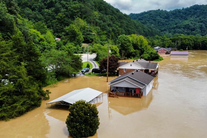 Catastrophic flash floods killed dozens of people in eastern Kentucky in July 2022. Here, homes in Jackson, Ky., are flooded with water.