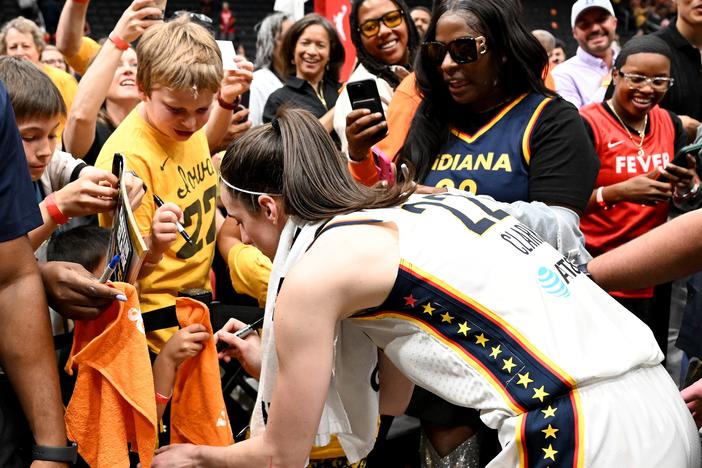 Caitlin Clark, the heralded Indiana Fever rookie, signs autographs after a game against the Washington Mystics that was attended by more than 20,000 fans, the highest attendance for a WNBA game in 17 years. 