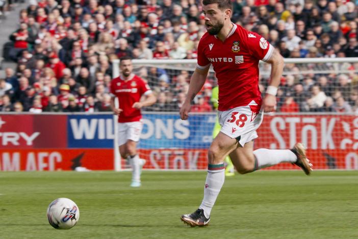  Elliot Lee moves the ball for Wrexham.