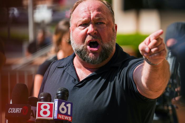 Infowars founder Alex Jones speaks to the media outside Waterbury Superior Court during his 2022 defamation trial in Waterbury, Conn.
