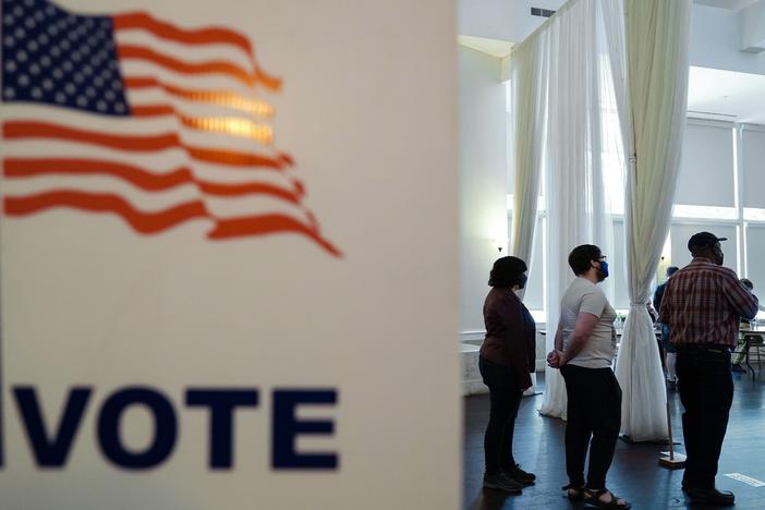 People wait in line to vote in Georgia's 2022 primary election in Atlanta.